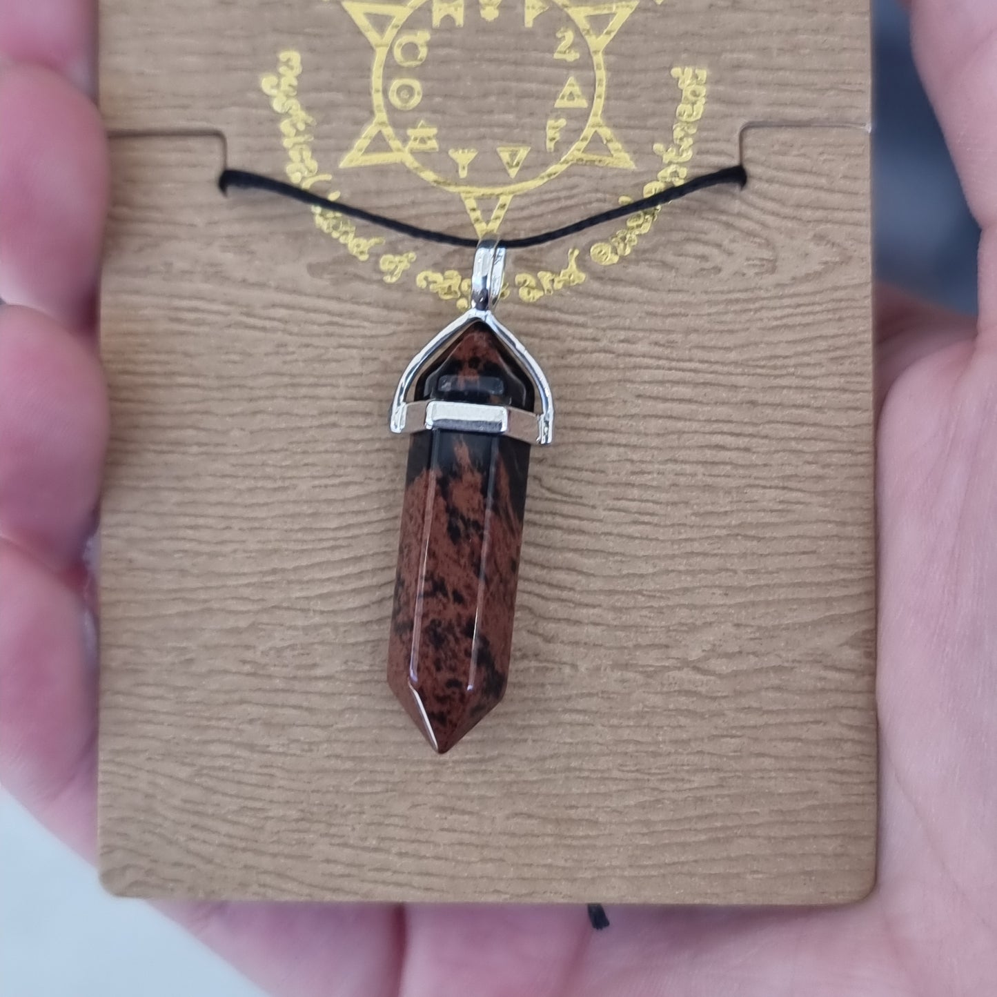 Mahogany obsidian pendant on card - Rivendell Shop